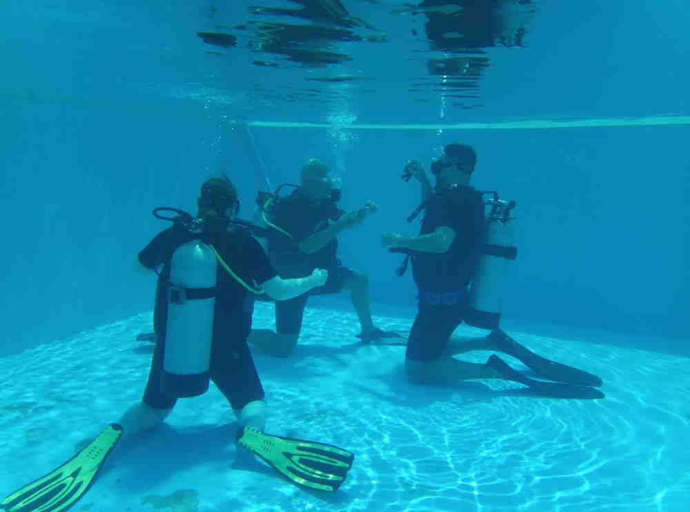 New divers in training with Steven from Phuket dash Scuba in a swimming pool.